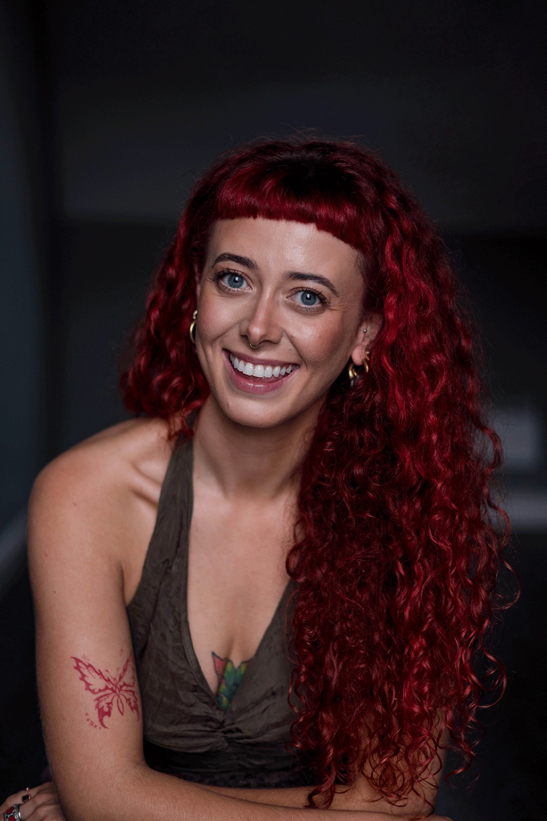 Emily Lamey smiling in a studio portrait.