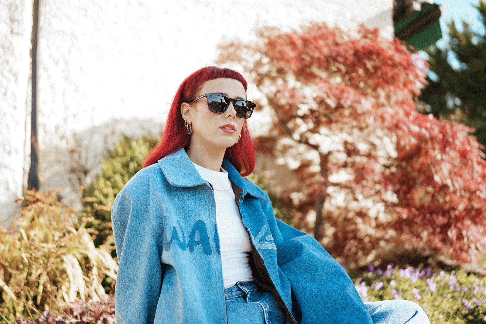 Emily Lamey wearing sunglasses and denim in autumn sunshine.