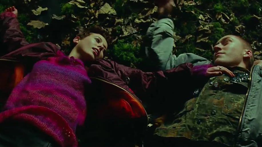 Two teenagers lying among autumn leaves in Every Breaking Wave.