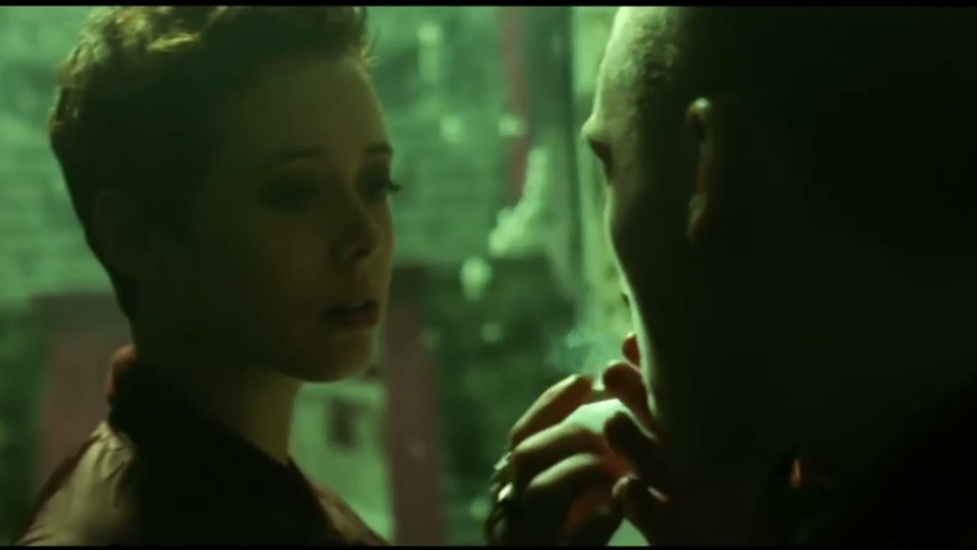 Emily Lamey in a green-lit music venue scene from Kneecap.